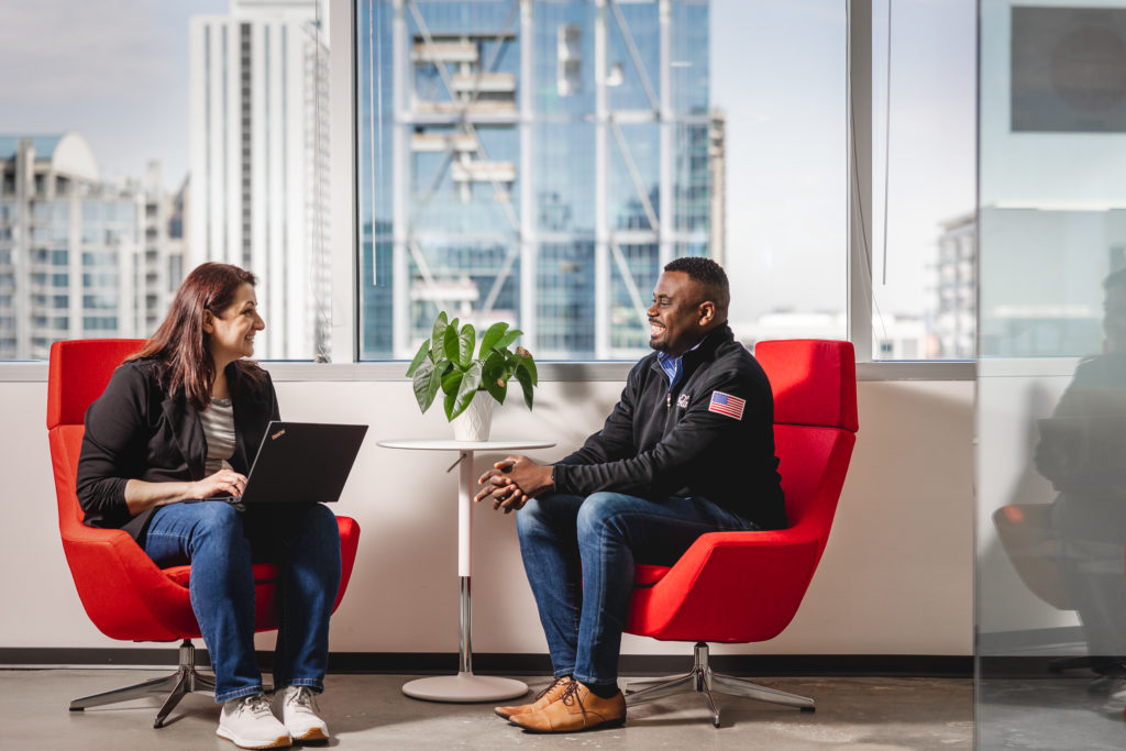 two people talking at cona services office