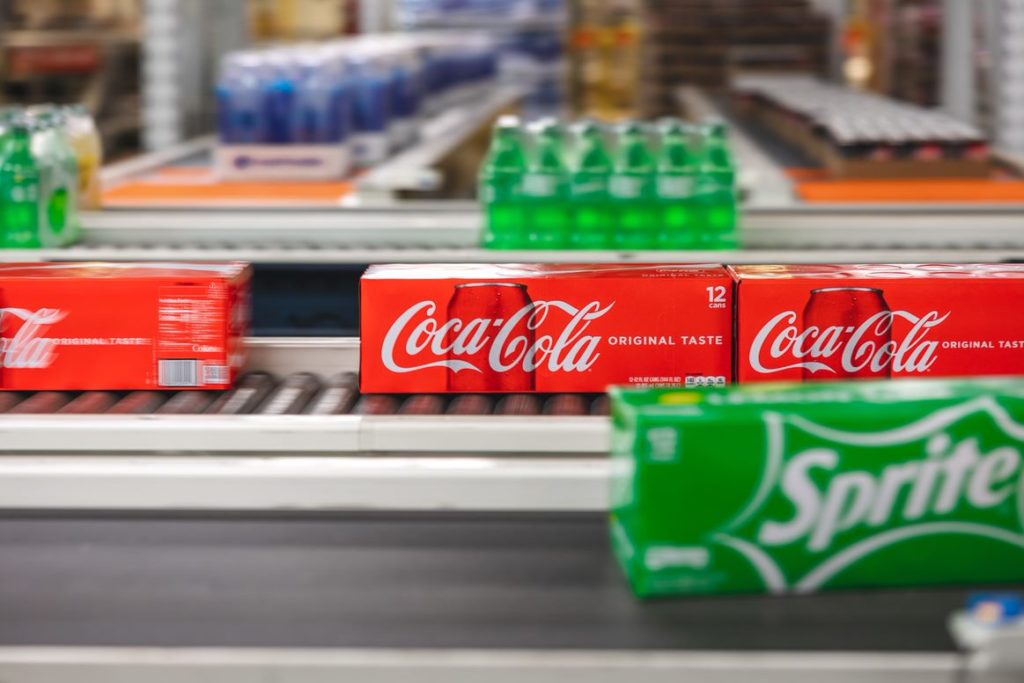 cases of coca-cola and sprint on belt